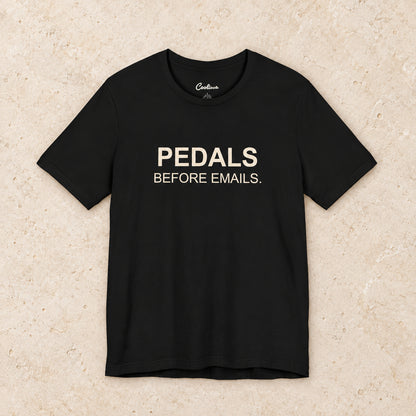 Pedals Before Emails. Bella+Canvas3001 T-shirt in Black, front flat lay.