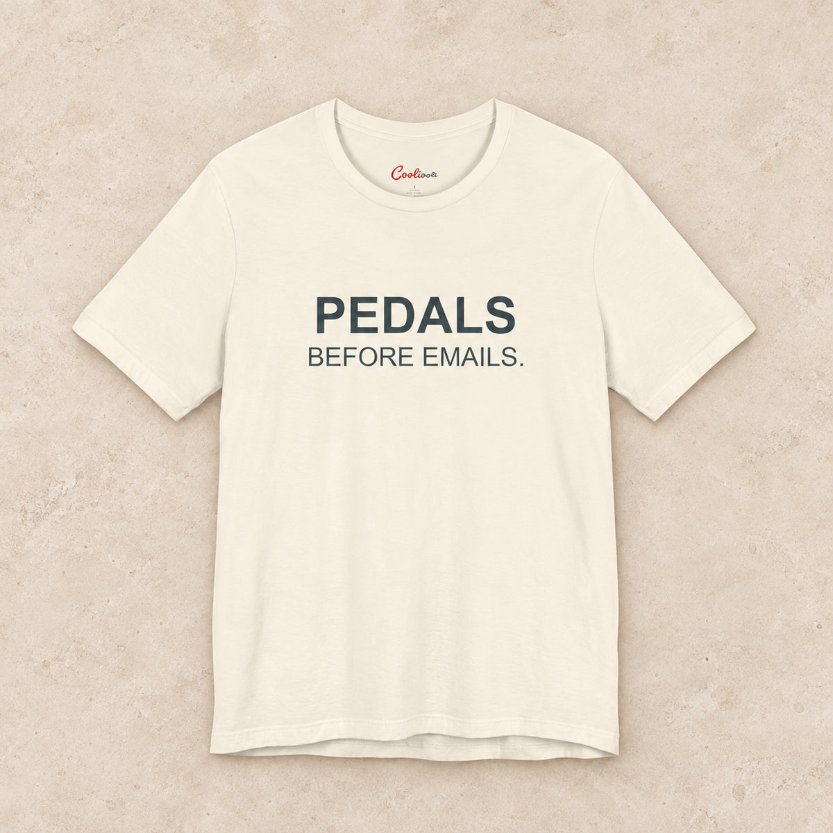 Pedals Before Emails. Bella+Canvas3001 T-shirt in Natural, front flat lay.
