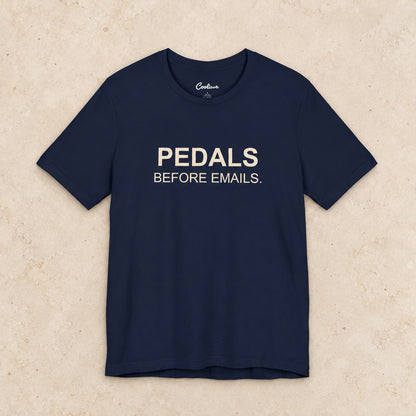 Pedals Before Emails. Bella+Canvas3001 T-shirt in Navy, front flat lay.