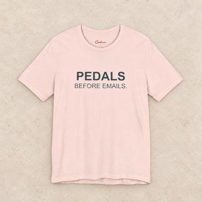 Pedals Before Emails. Bella+Canvas3001 T-shirt in Soft Pink, front flat lay.