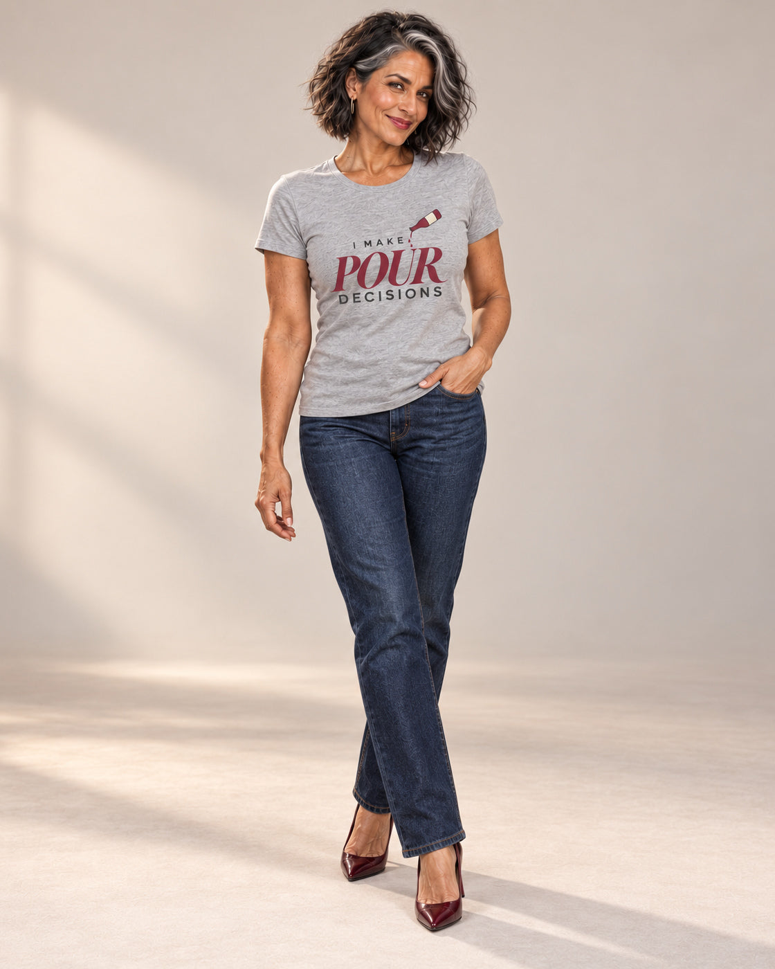 Freya wearing Blame the Vintage. in Athletic Heather with straight-leg jeans and burgundy heels; I Make Pour Decisions wine-bottle artwork.