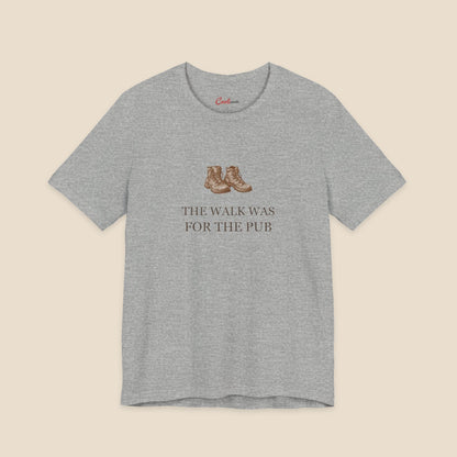 Athletic Heather Bella+Canvas3001 T-shirt with a brown hiking boots graphic and The Walk Was for the Pub serif lettering.