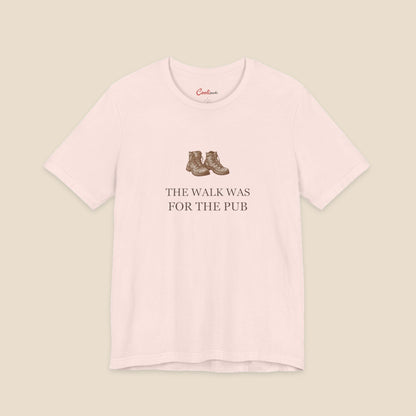 Soft Pink Bella+Canvas3001 T-shirt with a brown hiking boots graphic and The Walk Was for the Pub serif lettering.