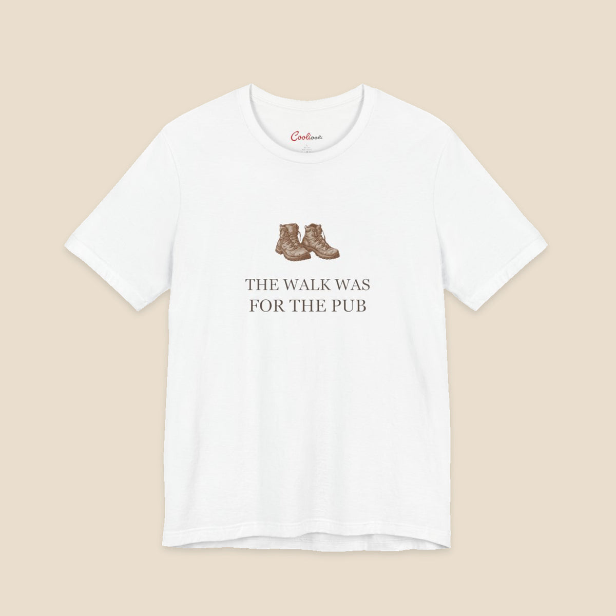 White Bella+Canvas3001 T-shirt with a brown hiking boots graphic and The Walk Was for the Pub serif lettering.