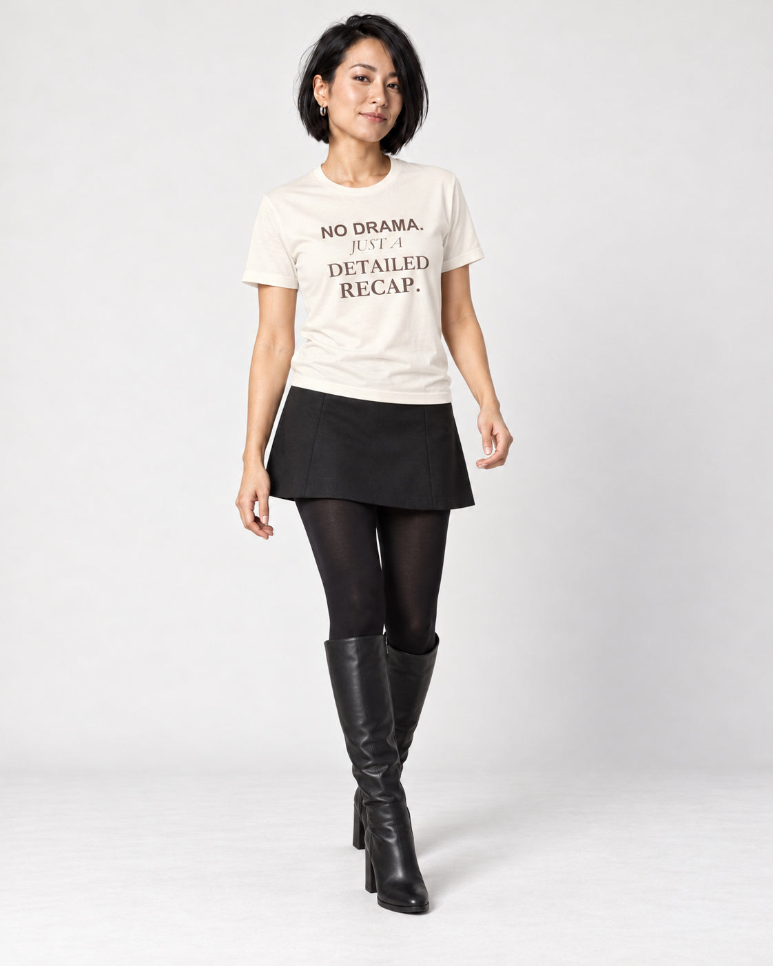 Mina wearing the Natural NO DRAMA. JUST A DETAILED RECAP. Bella+Canvas 3001 tee — full-length natural studio outfit