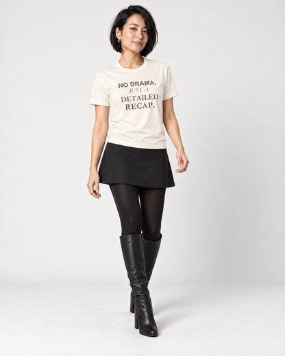 Mina wearing the Natural NO DRAMA. JUST A DETAILED RECAP. Bella+Canvas 3001 tee — full-length natural studio outfit