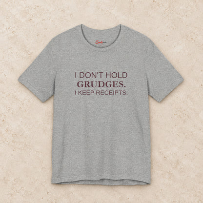 I Don't Hold Grudges. I Keep Receipts. Bella+Canvas3001 T-shirt in Athletic Heather, front flat lay.