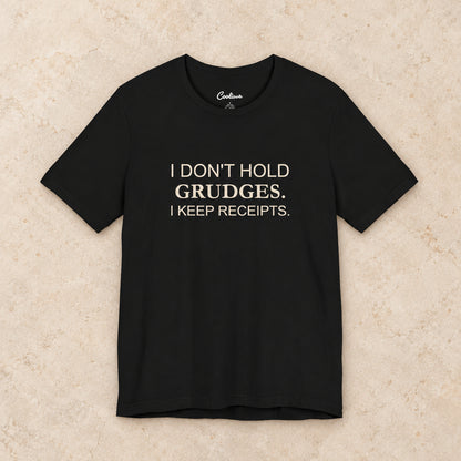 I Don't Hold Grudges. I Keep Receipts. Bella+Canvas3001 T-shirt in Black, front flat lay.