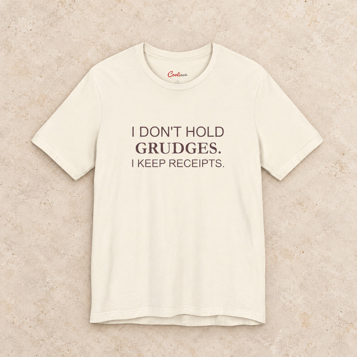 I Don't Hold Grudges. I Keep Receipts. Bella+Canvas3001 T-shirt in Natural, front flat lay.