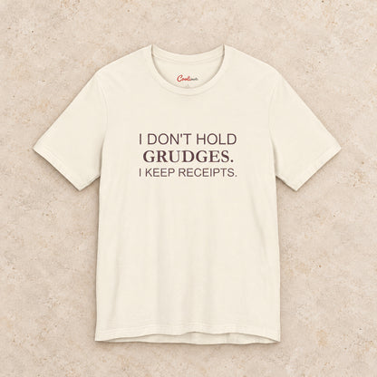 I Don't Hold Grudges. I Keep Receipts. Bella+Canvas3001 T-shirt in Natural, front flat lay.