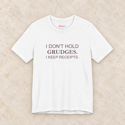 I Don't Hold Grudges. I Keep Receipts. Bella+Canvas3001 T-shirt in White, front flat lay.