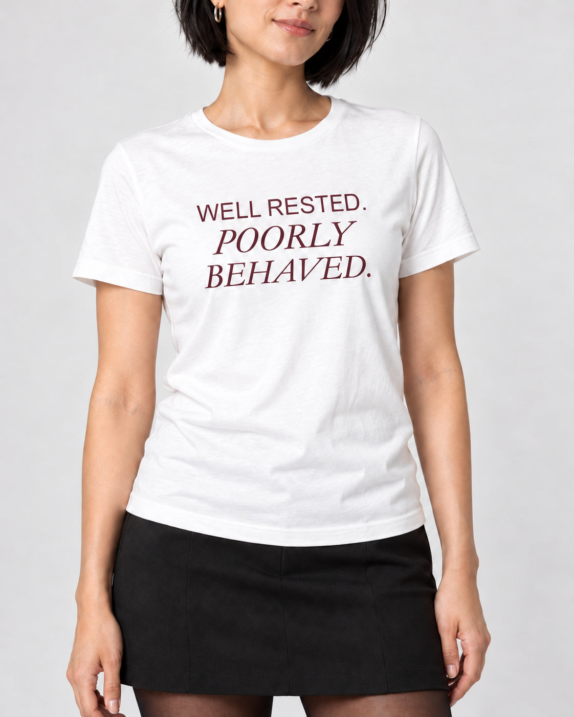 Close-up of WELL RESTED. POORLY BEHAVED. printed on the White Bella+Canvas3001 T-shirt.