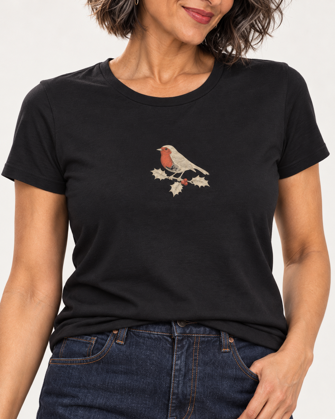Collar-to-hip detail of the Black Bella+Canvas3001 T-shirt showing the small red-breasted robin and bronze holly illustration.