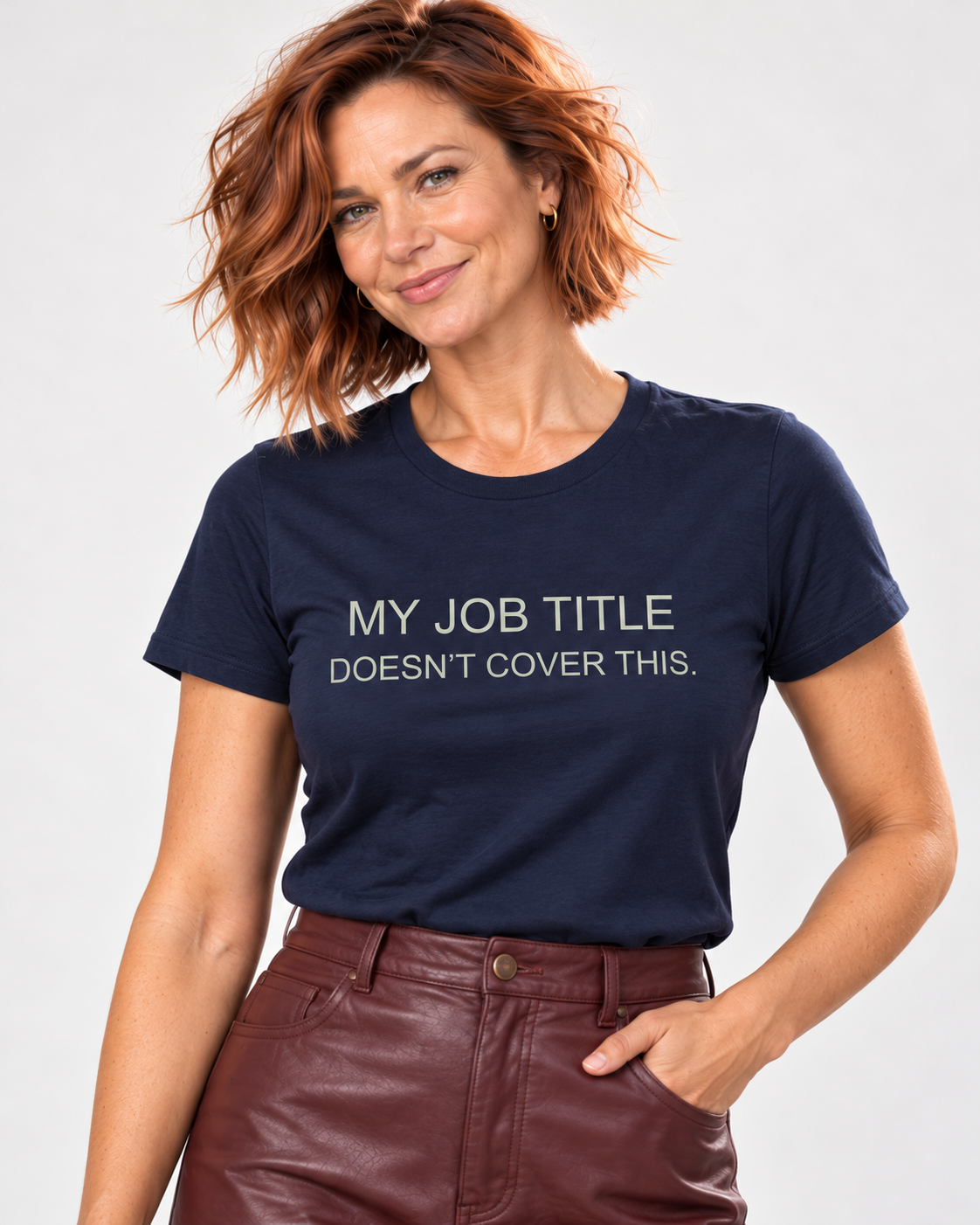 Close detail of the Navy Bella+Canvas 3001 T-shirt with pale sage My Job Title Doesn’t Cover This lettering printed into plain cotton jersey.