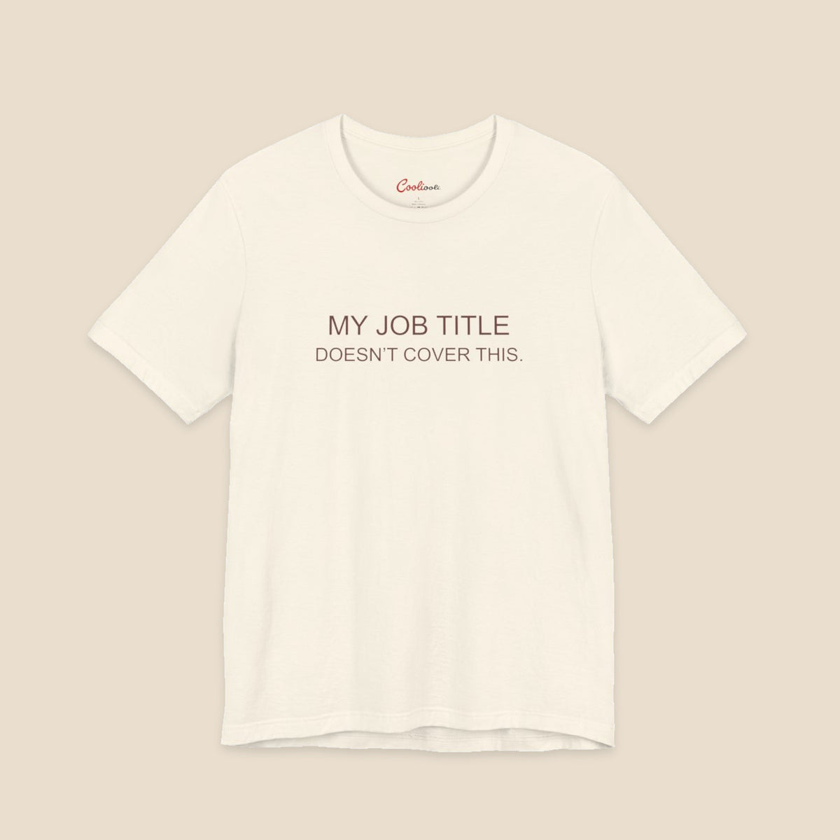 Natural Bella+Canvas 3001 work humour T-shirt with two-line My Job Title Doesn’t Cover This lettering.