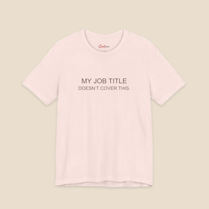Soft Pink Bella+Canvas 3001 work humour T-shirt with two-line My Job Title Doesn’t Cover This lettering.