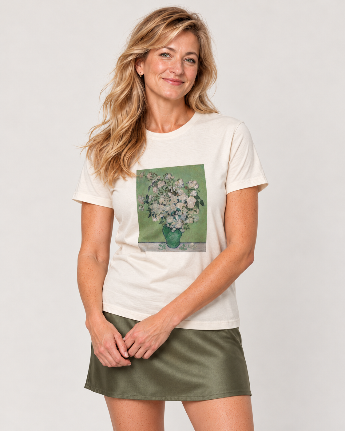 Elena wearing the Natural Van Gogh Roses Bella+Canvas 3001 tee with an olive satin mini skirt in the pale studio.