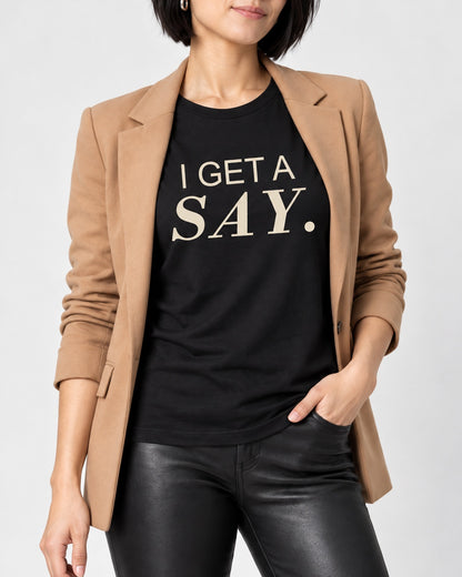 Mina wearing the Black I GET A SAY. Bella+Canvas 3001 tee — collar-to-hip print detail