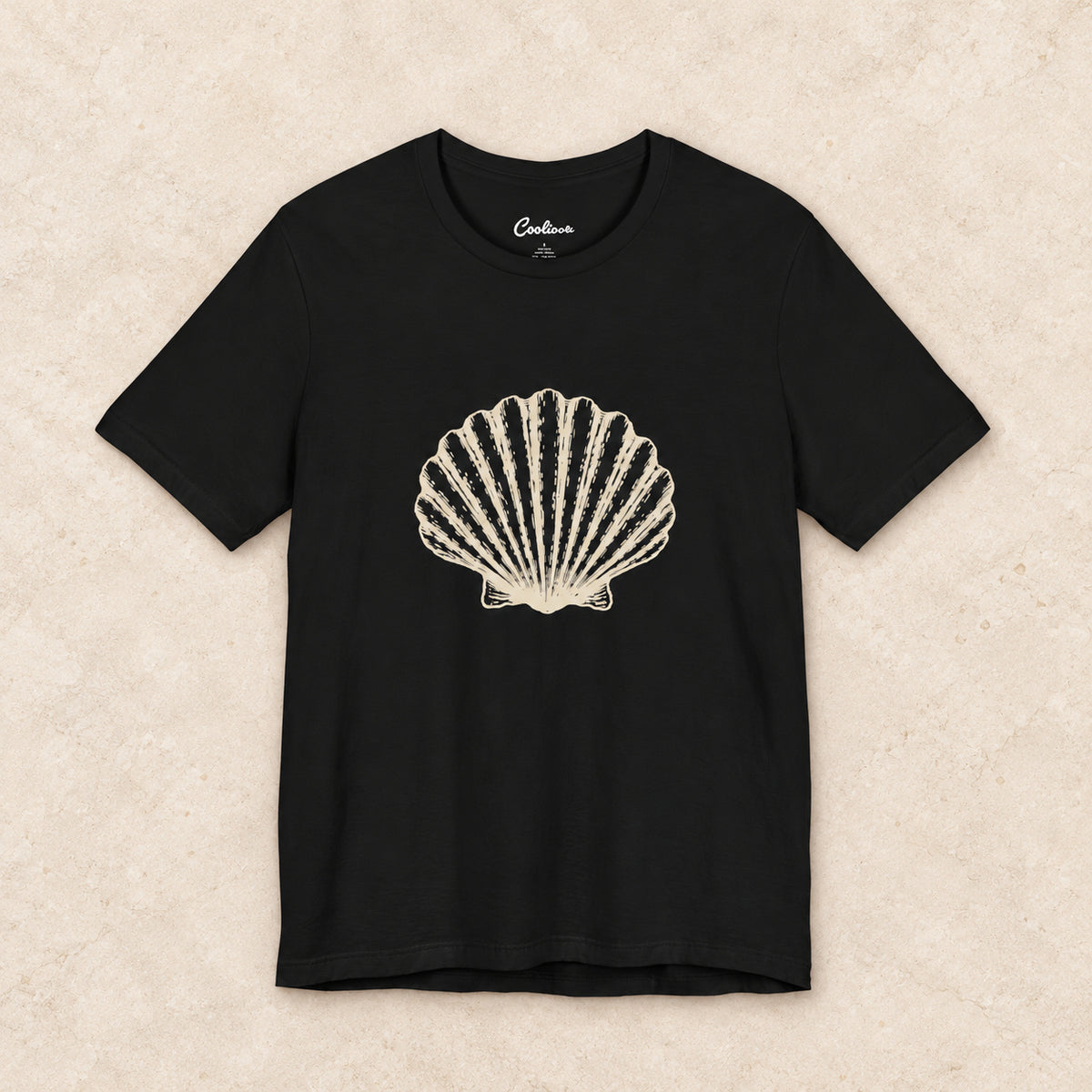 Original scallop shell Bella+Canvas3001 T-shirt in Black, front flat lay.
