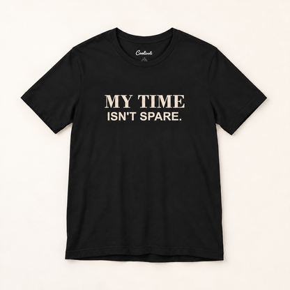 MY TIME ISN'T SPARE. Bella+Canvas 3001 tee in Black, overhead view on a plain warm neutral studio background