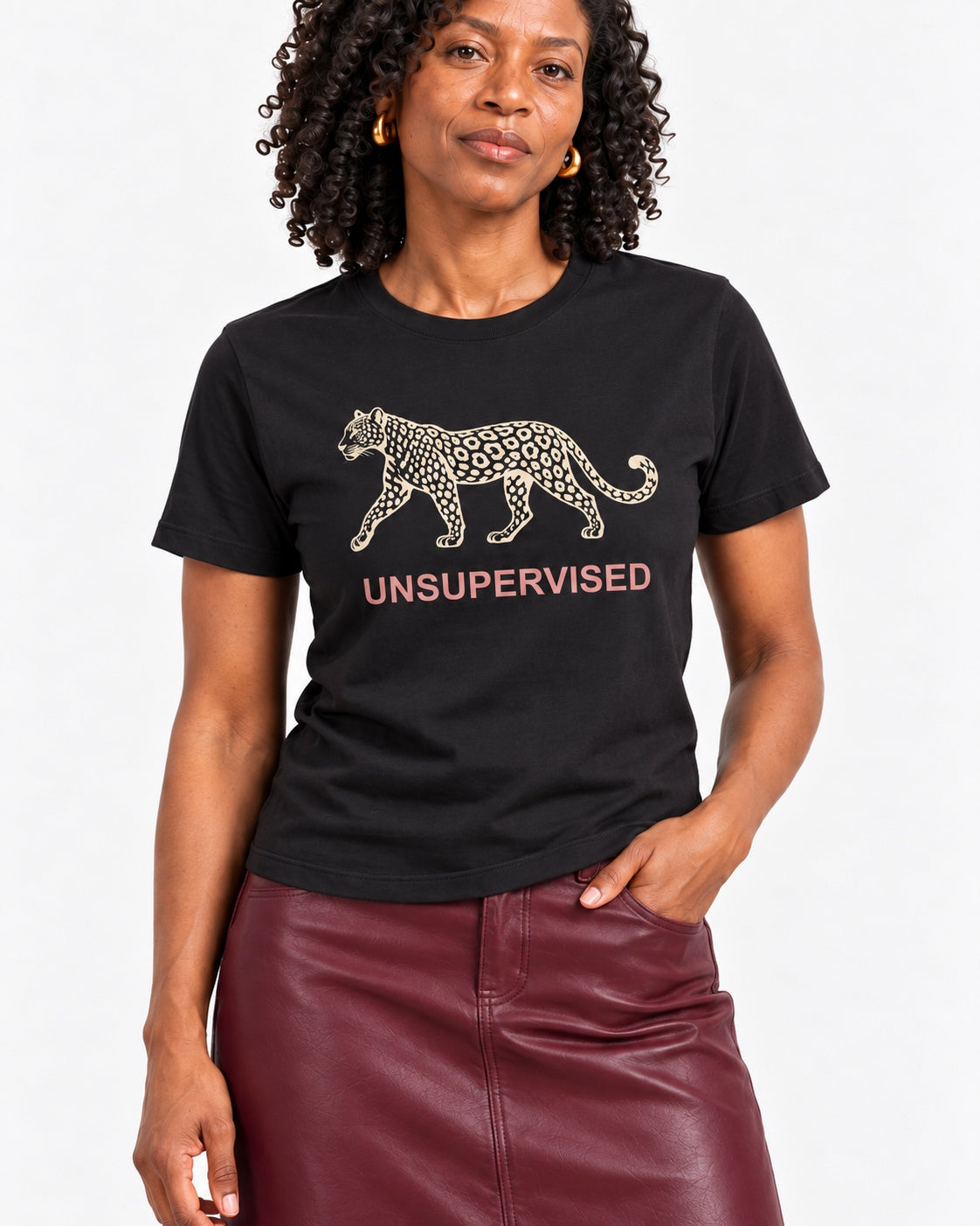 Close-up of Amara wearing the Black UNSUPERVISED leopard tee, with cream leopard and rose lettering following cotton folds
