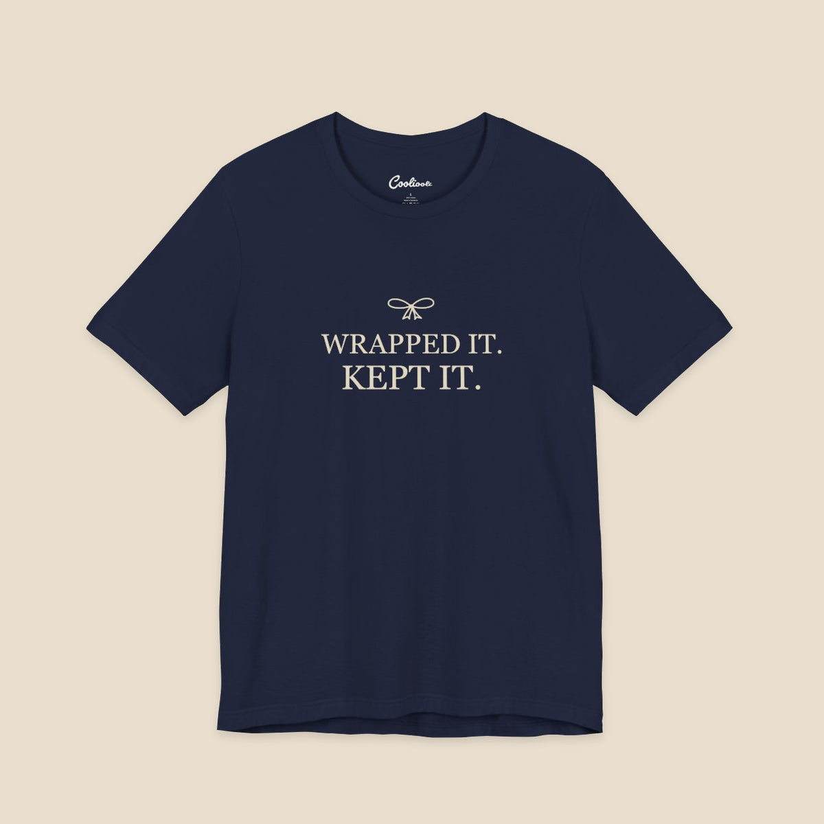 Navy Bella+Canvas 3001 T-shirt with Wrapped It. Kept It. lettering and a small ribbon bow.