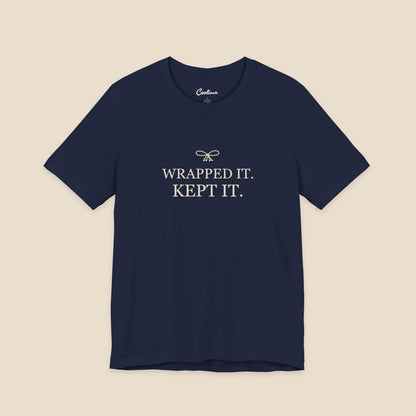 Navy Bella+Canvas 3001 T-shirt with Wrapped It. Kept It. lettering and a small ribbon bow.