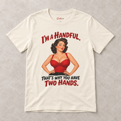 Natural Cooliooli T-shirt with the “I’m a handful. That’s why you have two hands.” pin-up design, front flat lay