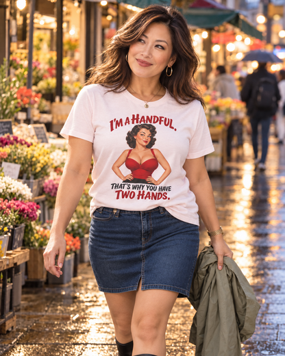 Lucy wearing a Soft Pink Cooliooli T-shirt with the “I’m a handful. That’s why you have two hands.” design and a short denim skirt at an evening flower market